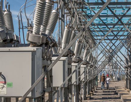 Workers performing maintenance at an electrical substation.